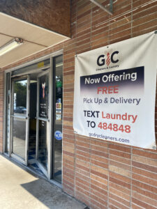 GC's main entrance, where a sign hangs announcing free pick up and delivery